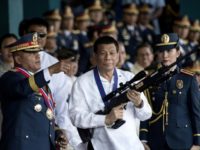 President Rodrigo Duterte (C with outgoing police chief Ronald dela Rosa L) has overseen a bloody anti-drug war that has killed more than 4,000 people