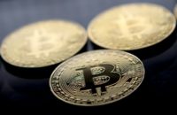 Gold plated souvenir Bitcoin tokens are displayed in London on November 20, 2017