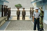 It ends here: North Korean soldiers stand just metres from their South Korean counterparts in the DMZ, one of the most tense borders on Earth