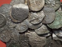 Germany Silver Treasure The April 13, 2018 photo shows medieval Saxonian, Ottoman, Danish and Byzantine coins after a medieval silver treasure had been found near Schaprode on the northern German island of Ruegen in the Baltic Sea. (Stefan Sauer/dpa via AP) Archaeologists find silver treasure on German Baltic island