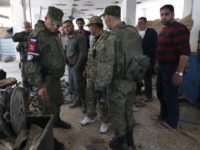 Russian military police officers check weapons left behind by members of the Army of Islam group in a factory produced weapons, in the town of Douma, the site of a suspected chemical weapons attack, near Damascus, Syria, Monday, April 16, 2018. Faisal Mekdad, Syria's deputy foreign minister, said on Monday that his country is "fully ready" to cooperate with the fact-finding mission from the Organization for the Prohibition of Chemical Weapons that's in Syria to investigate the alleged chemical attack that triggered U.S.-led airstrikes. (AP Photo/Hassan Ammar)