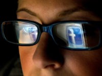 FILE: In this file photo the Facebook Inc. logo is reflected in the eyeglasses of a user in this arranged photo in San Francisco, California, U.S., on Wednesday, Dec. 7, 2011. A Facebook IPO would provide funds to help the social-networking service maintain its expansion and fend off competition from Internet rivals such as Google Inc. and Twitter Inc. Photographer: David Paul Morris/Bloomberg via Getty Images