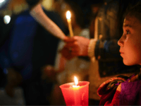 People hold candles as they attend a prayer vigil for terminally ill toddler Alfie Evans, in St. Peter's Square at the Vatican, Thursday, April 26, 2018. The British hospital treating Alfie Evans withdrew his life support Monday after a series of court rulings sided with the doctors and blocked further medical treatment. On Wednesday the Court of Appeal rejected a new bid by the parents to take Alfie to the Vatican's hospital in Rome. (AP Photo/Andrew Medichini)