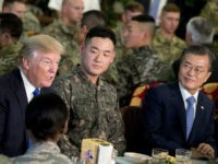 U.S. President Donald Trump and South Korean President Moon Jae-in, right, have lunch with U.S. and South Korean troops at Camp Humphreys in Pyeongtaek, South Korea, Tuesday, Nov. 7, 2017. Trump is on a five-country trip through Asia traveling to Japan, South Korea, China, Vietnam and the Philippines. (AP Photo/Andrew Harnik)