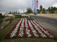 Flowers decorated as an American flag are seen on a road leading to the US Embassy compound ahead the official opening in Jerusalem, Sunday, May 13, 2018. On Monday, the United States moves its embassy in Israel from Tel Aviv to Jerusalem, the holy city at the explosive core of the Israeli-Palestinian conflict and claimed by both sides as a capital. The inauguration comes five months after President Donald Trump recognized Jerusalem as Israel's capital. (AP Photo/Ariel Schalit)