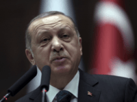 Turkish President Recep Tayyip Erdogan addresses the members of his ruling party at the parliament in Ankara, Turkey, Tuesday, March 20, 2018. Erdogan has called on the United States to "show respect" and "walk with" its NATO ally, in new criticism of Washington over its engagement with Syrian Kurdish militia. Erdogan's comments on Tuesday were in reply to statements from the U.S. State Departments voicing concern over Turkey's cross border offensive in northwestern Syrian enclave of Afrin, which Turkish troops and allied Syrian forces captured from the Syrian militia on Sunday.(AP Photo/Burhan Ozbilici)