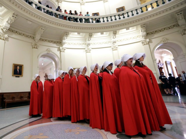 Activists dressed as characters from "The Handmaid's Tale" chant in the Texas Capitol Rotunda as they protest SB8, a bill that would require health care facilities, including hospitals and abortion clinics, such as Planned Parenthood, to bury or cremate any fetal remains whether from abortion, miscarriage or stillbirth, and they would be banned from donating aborted fetal tissue to medical researchers, Tuesday, May 23, 2017, in Austin. (AP Photo/Eric Gay)