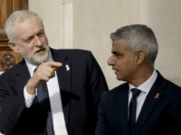 Britain's opposition Labour party leader Jeremy Corbyn, left, talks with London mayor Sadiq Khan, as they wait to pose for a group photograph after the Memorial Service to commemorate the 25th anniversary of the murder of black teenager Stephen Lawrence at St Martin-in-the-Fields church in London, Monday, April 23, 2018. (AP Photo/Matt Dunham)