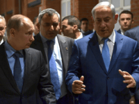 Russian President Vladimir Putin, left, and Israeli Prime Minister Benjamin Netanyahu, right, walk during their meeting marking 75th anniversary of the 75th anniversary of the Sobibor uprising, the only successful uprising that took place in a death camp during World War II at the Jewish Museum and Tolerance Center in Moscow in Moscow, Russia, Monday, Jan. 29, 2018. (Alexei Nikolsky, Sputnik, Kremlin Pool Photo via AP)
