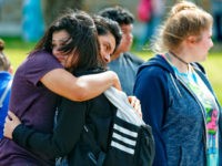 students-embrace-after-santa-fe-school-shooting-5-18-18-ap Santa Fe High School freshman Caitlyn Girouard, center, hugs her friend outside the Alamo Gym where students and parents wait to reunite following a shooting at Santa Fe High School Friday, May 18, 2018, in Santa Fe, Texas. (Michael Ciaglo/Houston Chronicle via AP)