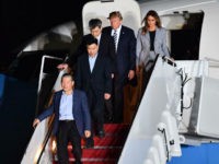 US President Donald Trump (2nd R) and his wife Melania Trump (R) walk down the stairs with US detainees Tony Kim (2nd L), Kim Dong-chul (bottom L) and Kim Hak-song (C) upon their return after they were freed by North Korea, at Joint Base Andrews in Maryland on May 10, 2018. - US President Donald Trump greeted the three US citizens released by North Korea at the air base near Washington early on May 10, underscoring a much needed diplomatic win and a stepping stone to a historic summit with Kim Jong Un. (Photo by Nicholas Kamm / AFP) (Photo credit should read NICHOLAS KAMM/AFP/Getty Images)