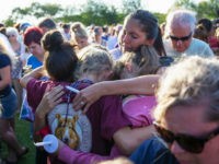 vigil-victims-santa-fe-school-shooting-getty SANTA FE, TX - MAY 18: Friends and family attend a vigil held at the First Bank in Santa Fe for the victims of a shooting incident at Santa Fe High School where a shooter killed at least 10 students on May 18, 2018 in Santa Fe, Texas. At least …