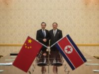 China's foreign minister Wang Yi (left) shakes hands with North Korea's foreign Minister Ri Yong Ho at the Mansudae Assembly Hall in Pyongyang on May 2, 2018