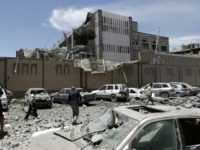 Yemenis check the presidential office building in the rebel-held capital Sanaa on May 7, 2018 after it was hit by air strikes that reportedly killed six people and wounded 30