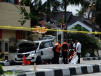 Indonesian policemen examine a car used by attackers during an assault on a police headquarters on the island of Sumatra that left one officer dead and two wounded Indonesian policemen examine a car used by attackers during an assault on a police headquarters on the island of Sumatra that left one officer dead and two wounded