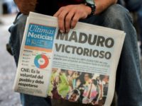 A man holds a newspaper referring to the victory of re-elected President Nicolas Maduro in the Venezuelan presidential election in Caracas. A man holds a newspaper referring to the victory of re-elected President Nicolas Maduro in the Venezuelan presidential election in Caracas.