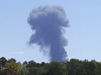 Smoke rises in the distant where an Air National Guard C-130 cargo plane crashed near an in Savannah, Ga., Wednesday, May 2, 2018, in this view from Poolers, Ga. (Minh Phan via AP)