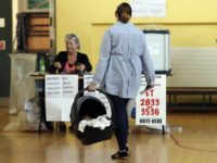 Ireland Abortion Referendum A woman carries a baby in a cot as goes to cast her vote at a polling station in the referendum on the 8th Amendment of the Irish Constitution, in Dublin, Friday, May 25, 2018. Voters throughout Ireland have begun casting votes in a referendum that may lead to a loosening of the country's strict ban on most abortions. (Niall Carson/PA via AP) The Latest: Activists welcome Irish returning home to vote
