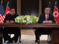 SINGAPORE-US-NKOREA-DIPLOMACY-SUMMIT US President Donald Trump (R) speaks while seated with North Korea's leader Kim Jong Un (L) at a signing ceremony during their historic US-North Korea summit, at the Capella Hotel on Sentosa island in Singapore on June 12, 2018. - Donald Trump and Kim Jong Un became on June 12 …