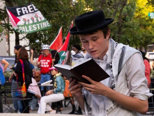 Eli, a ordothox Jewish man who supports pro-Palestine protesters, prays during a protest i