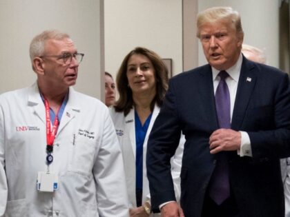 Surgeon Dr. John Fildes walks with President Donald Trump at University Medical Center, Oc