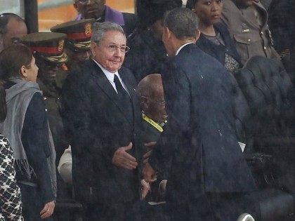 Raul Castro and Barack Obama greet at Mandela funeral in 2013 (AP)