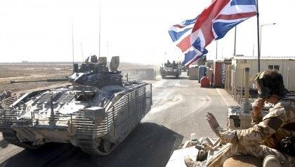 A convoy of British armoured vehicles arrive to contingency operating base after pulling o