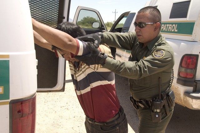 CBP Border Patrol agent does a pat down of a Mexican being returned to Mexico.