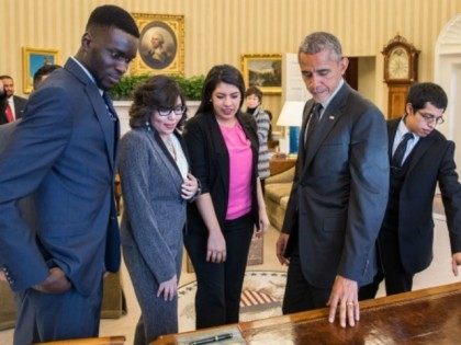 President Barack Obama shows the Resolute Desk to a group of DREAMers, following their Ova