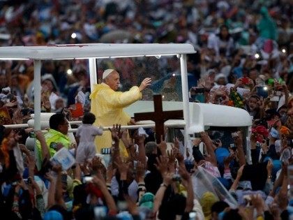 Pope Francis waves from the popemobile after leading a Mass at Rizal Park in Manila