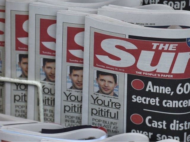 Copies of The Sun newspaper are seen on a newsstand …