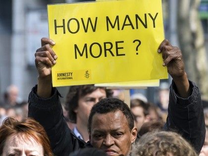 A protestor holds up a sign during a demonstration outside of an emergency EU summit in Brussels on Thursday, April 23, 2015. Protestors on Thursday called on EU leaders to take more effective action to save lives in the Mediterranean, where hundreds of migrants are missing and feared drowned in …