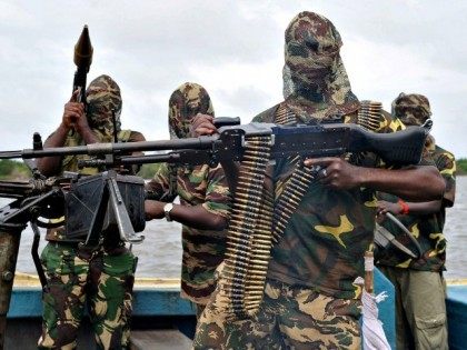 Boko Haram members poised with guns, ammunition, camouflage, masks