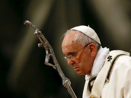 Pope Francis holds a crucifix as he lead the Easter vigil mass in Saint Peter's basilica at the Vatican