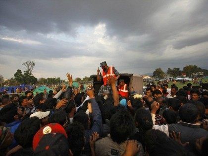 A police officer gives out emergency tents to survivors (AP)