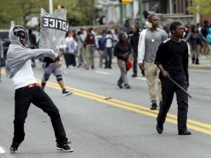 Demonstrators throw rocks at Baltimore police during clashes in Baltimore