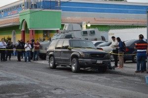 Mexican federal investigators gather evidence after a grenade went off outside of a federal building in Matamoros