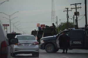 Federal authorities guard one of the buildings attacked by cartel gunmen during a grenade attack in Matamoros. 