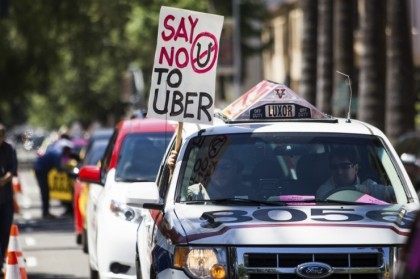Taxi drivers protest against transportation network companies such as Uber …