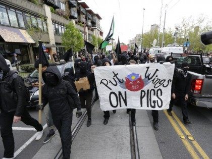 Anti-capitalist protesters take part in a May Day demonstration, Friday, May 1, 2015 in downtown Seattle. (AP Photo/Ted S. Warren)