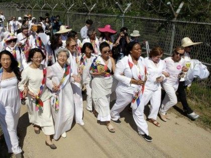 U.S. activist Gloria Steinem, seventh from right, two Nobel Peace Prize laureates Mairead Maguire, from Northern Ireland, third from right, Leymah Gbowee, from Liberia, fourth from right, and other activists march to the Imjingak Pavilion with South Korea.