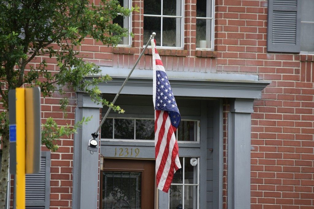 Memorial Day Weekend Flag partially ripped off of home's flagpole. Breitbart Texas Photo by Bob Price