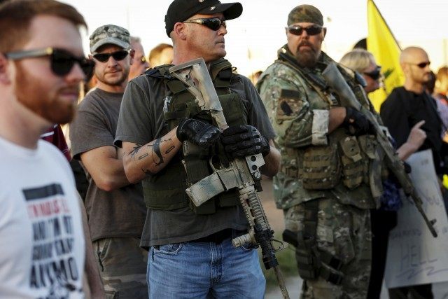 Men carrying rifles attend "Freedom of Speech Rally Round II" across from Islamic Communit