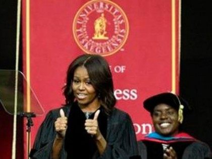 First Lady Michelle Obama gives thumbs up after walking on stage at Tuskegee University, S