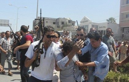 A woman attacks one of the suspects after he is arrested