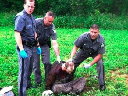 Police stand over David Sweat after he was shot and captured near the Canadian border Sund
