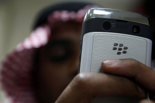 A Saudi man uses his Blackberry in the c