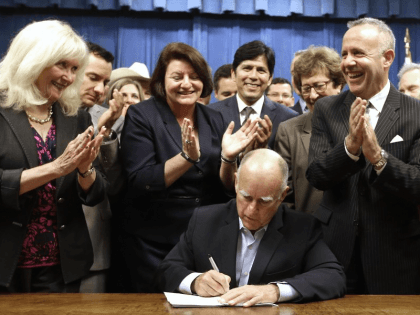Jerry Brown signs (Rich Pedroncelli / Associated Press)