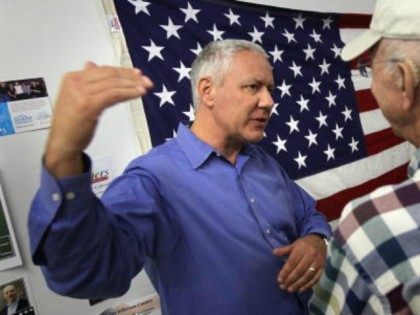Republican candidate for the U.S. Senate Ken Buck (L) speaks with supporters at a campaign