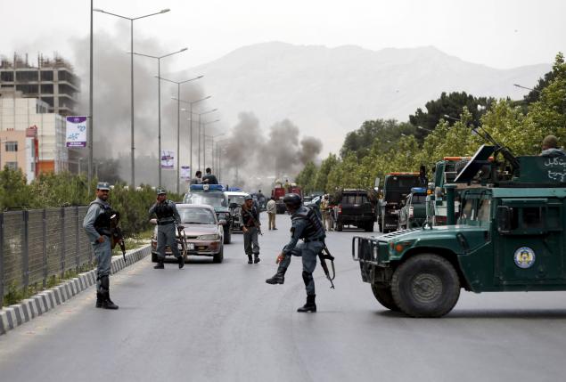 Smoke rises from the site of an attack near the Afghan parliament in Kabul, Afghanistan